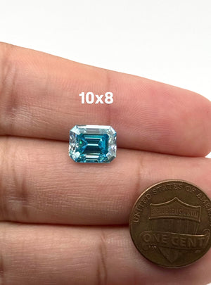 Sea blue emerald cut moissanite loose gemstone available in 8x6mm to 10x8mm sizes for custom jewelry.