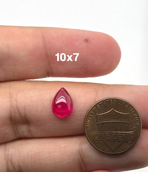 Lab Grown Ruby Pear Cabochon #5 polished red gemstone on white background