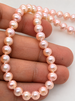 14K yellow gold clasp detail showing polished craftsmanship on hand knotted pearl necklace