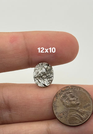 Black Rutilated Quartz oval cabochon stone with visible needle inclusions