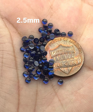 Lab Blue Sapphire 2.5mm round cabochon flat back parcel on white background