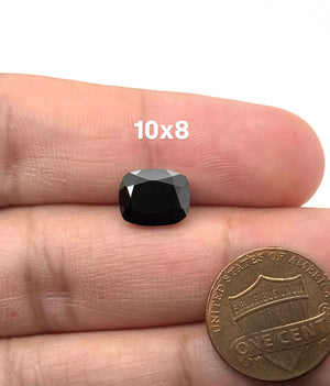Natural Black Spinel loose gemstone featuring a deep jet-black color in an elongated cushion cut measuring 10x8mm. This faceted gemstone displays excellent polish and luster, making it ideal for custom rings, pendants, earrings, and fine jewelry designs.