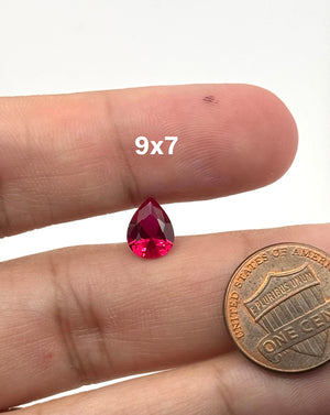 Lab Grown Ruby Pear #5 faceted red loose gemstone on white background