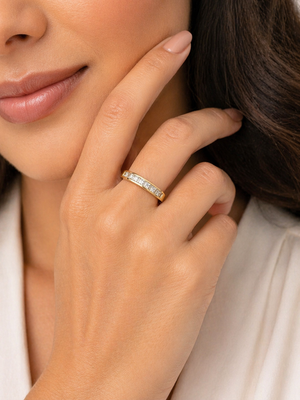 diamond band worn on finger styled for wedding or everyday jewelry look