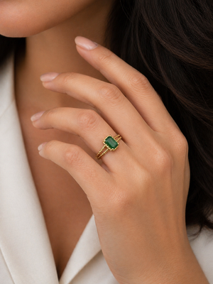 Emerald ring worn on finger styled for elegant everyday jewelry look