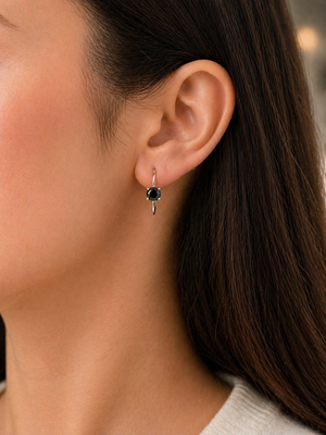 woman wearing black diamond studs for everyday elegant styling
