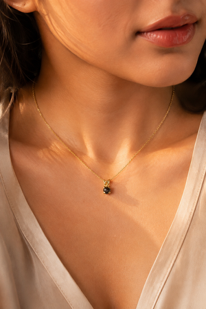 Black diamond pendant worn on neck with elegant evening styling and rose cut black diamond necklace 