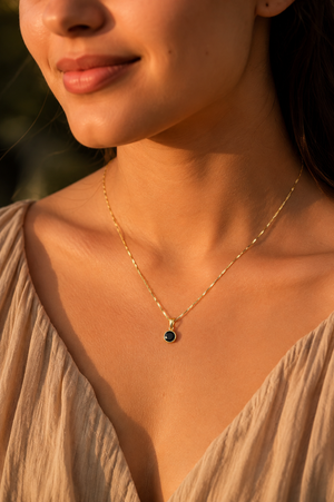 Black diamond pendant necklace worn with an evening outfit featuring a black diamond solitaire pendant necklace 