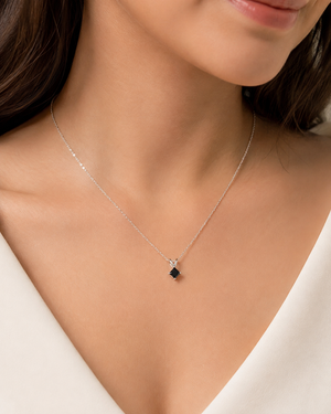 Black diamond pendant worn with white gold chain for an elegant princess cut black diamond necklace look 