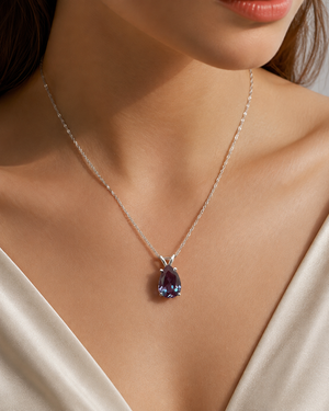 Lab created Alexandrite pendant worn on neckline for elegant pear cut Alexandrite necklace styling 