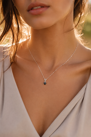 Woman wearing an 18K white gold pendant with an AAA black diamond pendant necklace styling 