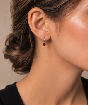 Woman wearing elegant garnet lever back earrings for everyday style.