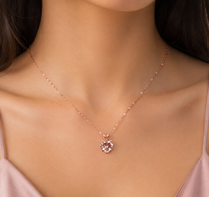 Woman wearing a rose gold heart morganite pendant for a romantic evening look