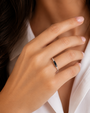 Woman wearing Black & White Diamond Ring during an elegant celebration showcasing princess cut diamond ring 