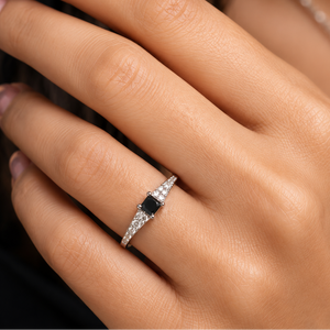 Woman wearing Black Diamond Ring on finger during an anniversary dinner featuring natural black and white diamonds 
