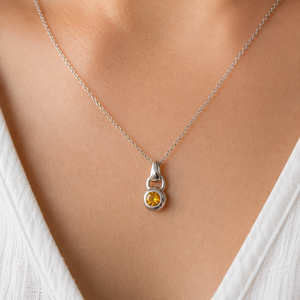 Woman wearing Citrine Solitaire Pendant as a Sterling Silver Citrine Necklace with casual everyday style 