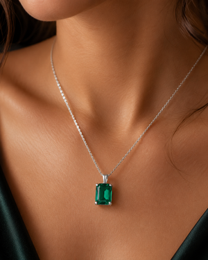 Woman wearing Natural Emerald Pendant with elegant evening outfit showcasing emerald solitaire pendant 