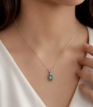 Woman wearing a 14K white gold emerald pendant necklace for an elegant natural emerald pendant necklace look 