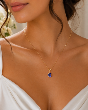 Woman wearing elegant tanzanite pendant necklace styled for anniversary dinner luxury jewelry inspiration