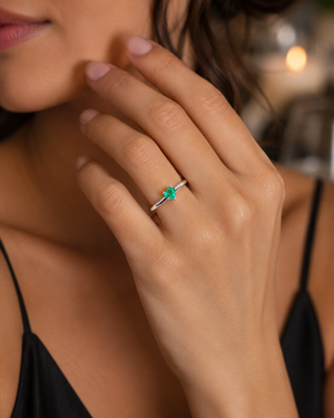 Woman wearing elegant emerald ring styled for anniversary dinner romantic jewelry inspiration