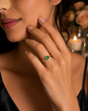 Woman wearing emerald ring at romantic dinner sophisticated anniversary jewelry styling