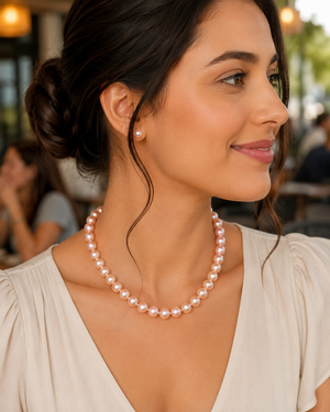 Woman wearing pink pearl necklace styled for anniversary dinner romantic fine jewelry gift