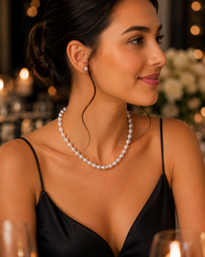 Woman wearing classic pearl strand necklace styled for formal dinner timeless jewelry accessory