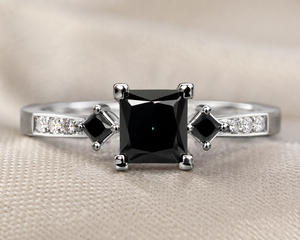 Flat lay three stone diamond ring with polished white gold elegant contemporary bridal styling