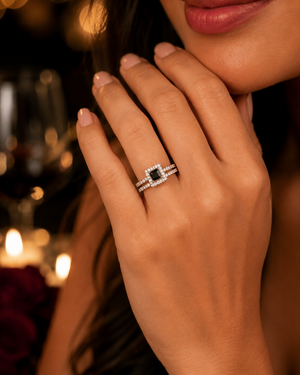 Woman wearing matching bridal ring set during proposal dinner, elegant engagement jewelry styling