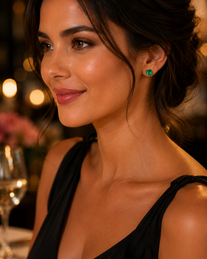 Woman wearing emerald stud earrings at birthday dinner, elegant gemstone jewelry styling