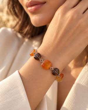 Woman wearing Carnelian Smokey Quartz Bracelet on wrist, styled as a silver gemstone charm bracelet 
