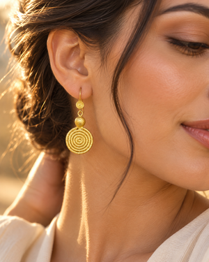 Yellow rhodium dangle earrings worn on pierced ears for an elegant evening look 