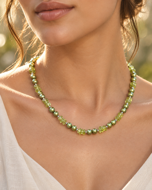 Peridot pearl necklace worn at the neckline, styled as a green freshwater pearl necklace for elegant occasions 
