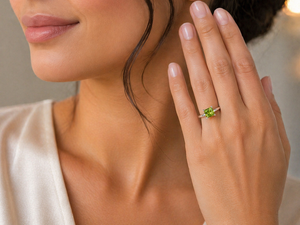 woman wearing green gemstone ring styled with neutral outfit