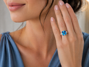 woman wearing bold blue gemstone ring with evening attire