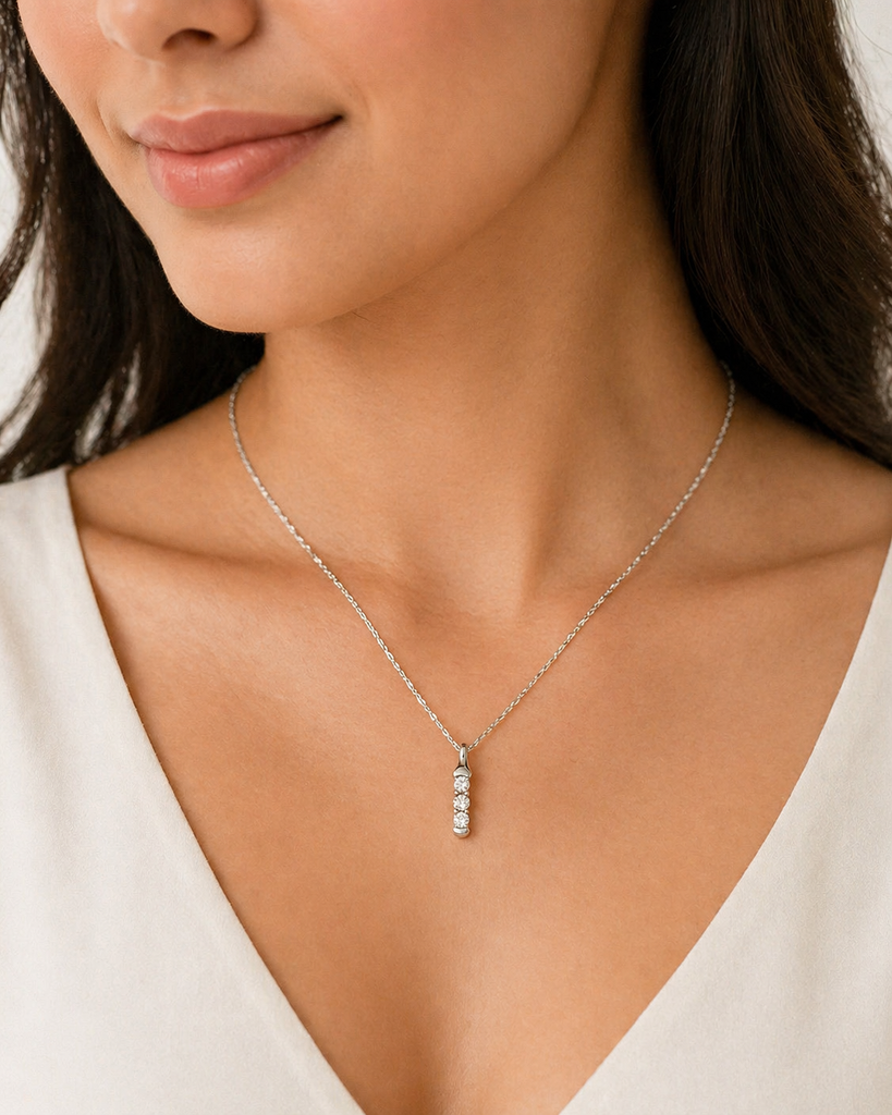 Woman wearing delicate diamond pendant necklace styled for everyday elegance look