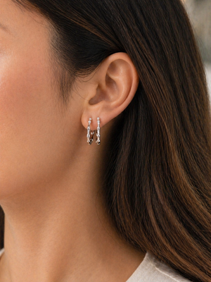 woman wearing white gold diamond hoops styled for everyday elegance