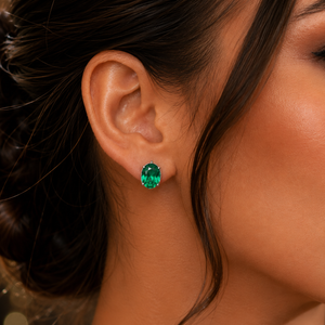 Earrings worn on ears during celebration with oval emerald earrings styling 