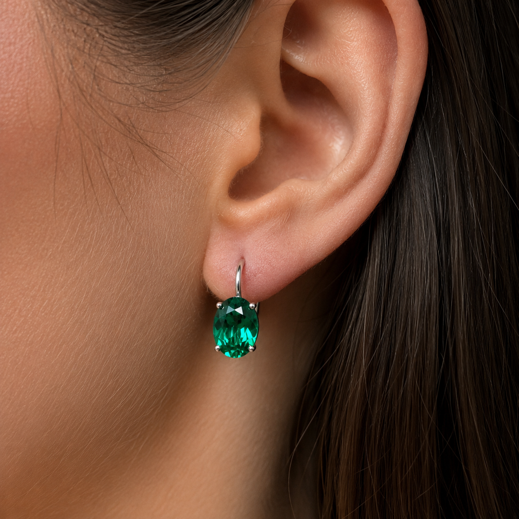 Emerald earrings worn on ears during evening occasion with oval emerald earrings styling 