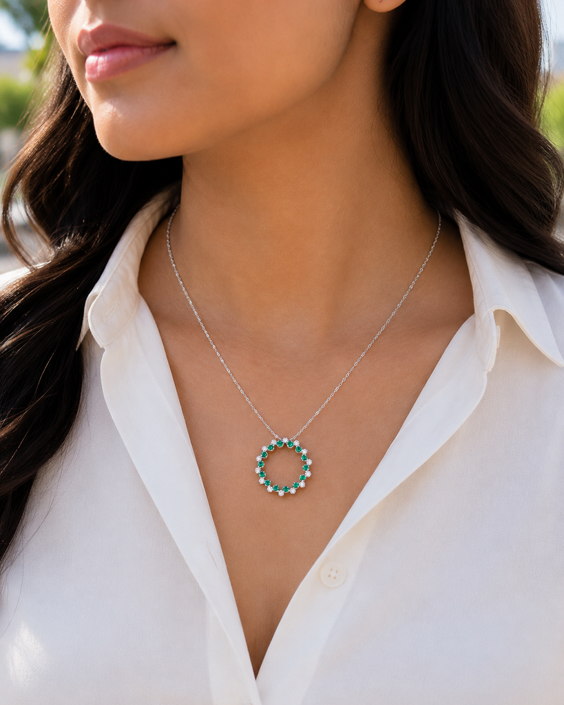 Woman wearing emerald circle necklace with evening styling for anniversary jewelry inspiration
