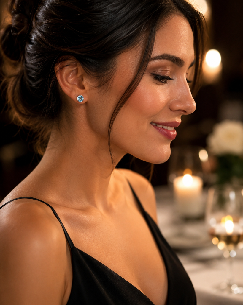 Woman wearing aquamarine stud earrings styled for anniversary dinner elegant fine jewelry