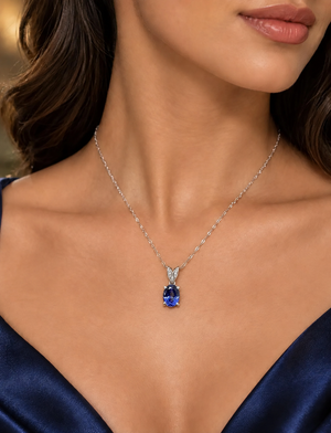 Oval Tanzanite pendant worn at the neckline with an elegant anniversary jewelry look