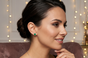 Woman wearing emerald stud earrings styled with evening outfit elegant jewelry gift