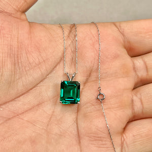 x10 mm emerald-cut lab created emerald solitaire pendant in 14K white gold with AAA green gemstone and 18 inch Singapore chain.
Large 5.26–6.12 cts womens white gold emerald necklace with prong-set synthetic emerald. 