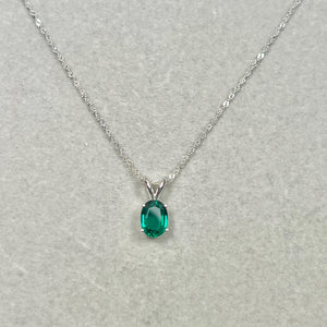 AAA lab created emerald solitaire pendant 1.06–1.21 carat oval 8x6mm set in solid 14k white gold with 18 inch chain.