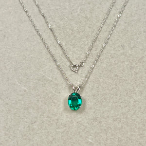 AAA lab created emerald solitaire pendant 1.58–2.00 carat oval 9x7mm set in solid 14k white gold with 18 inch chain.