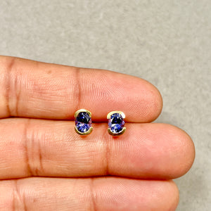 Oval tanzanite stud earrings in 14k yellow gold
