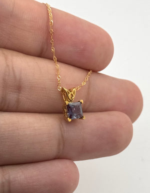 Elegant lab created alexandrite necklace pendant with scroll detailing and gold chain