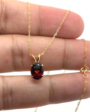 9x7mm Garnet Pendant | 14K Yellow Gold Oval Solitaire Necklace — January Birthstone Jewelry
