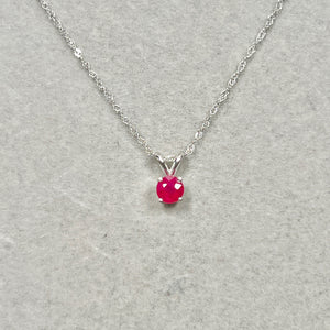 Artisan-cut 0.65 Cts Platinum Ruby Pendant featuring sculpted four-prong setting and saturated red round elegance